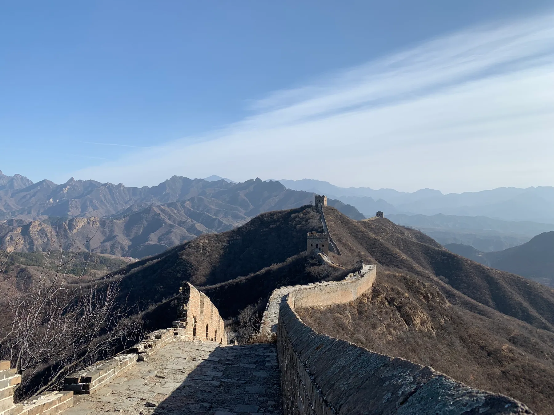 A Jinshanling Great Wall watchtower stretching across mountain ridges.