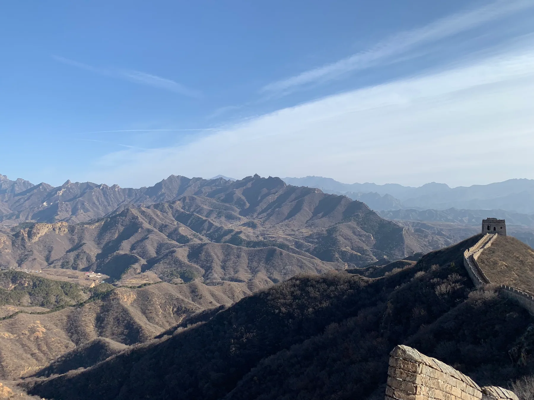 The Jinshanling Great Wall following steep brown hills.