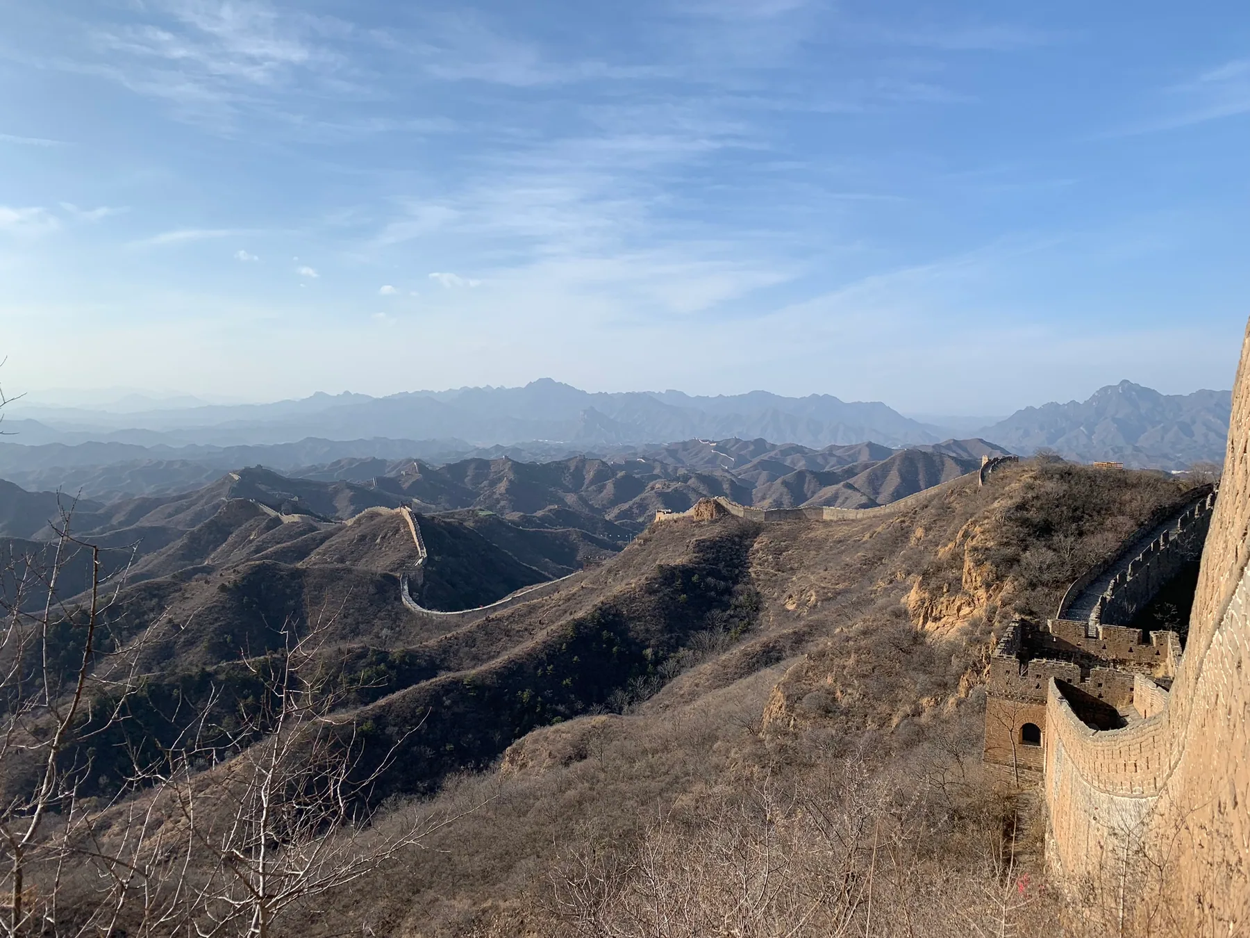 A rugged Jinshanling Great Wall section crossing dry mountains.
