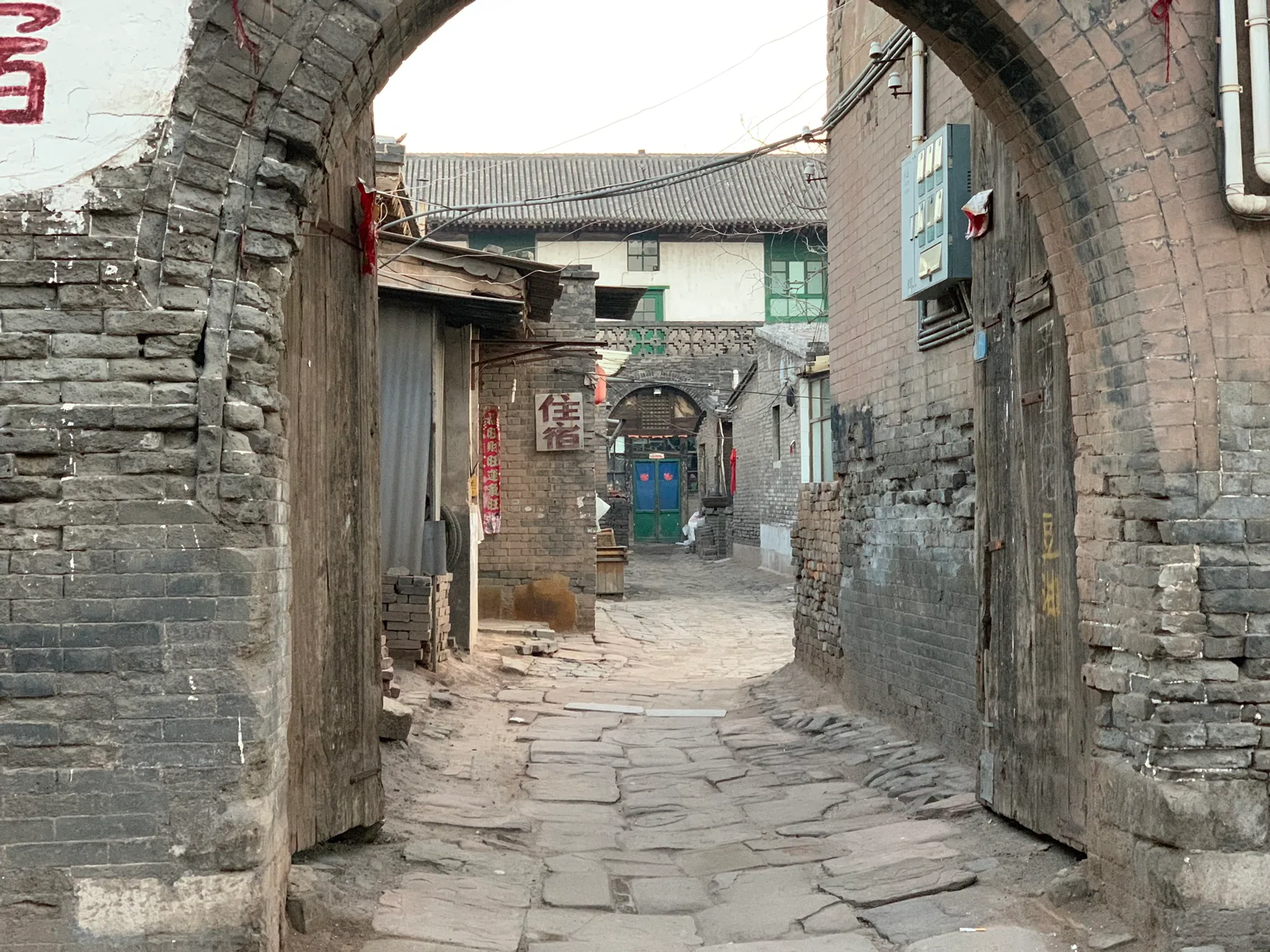 A narrow stone lane and arched passage in Pingyao.