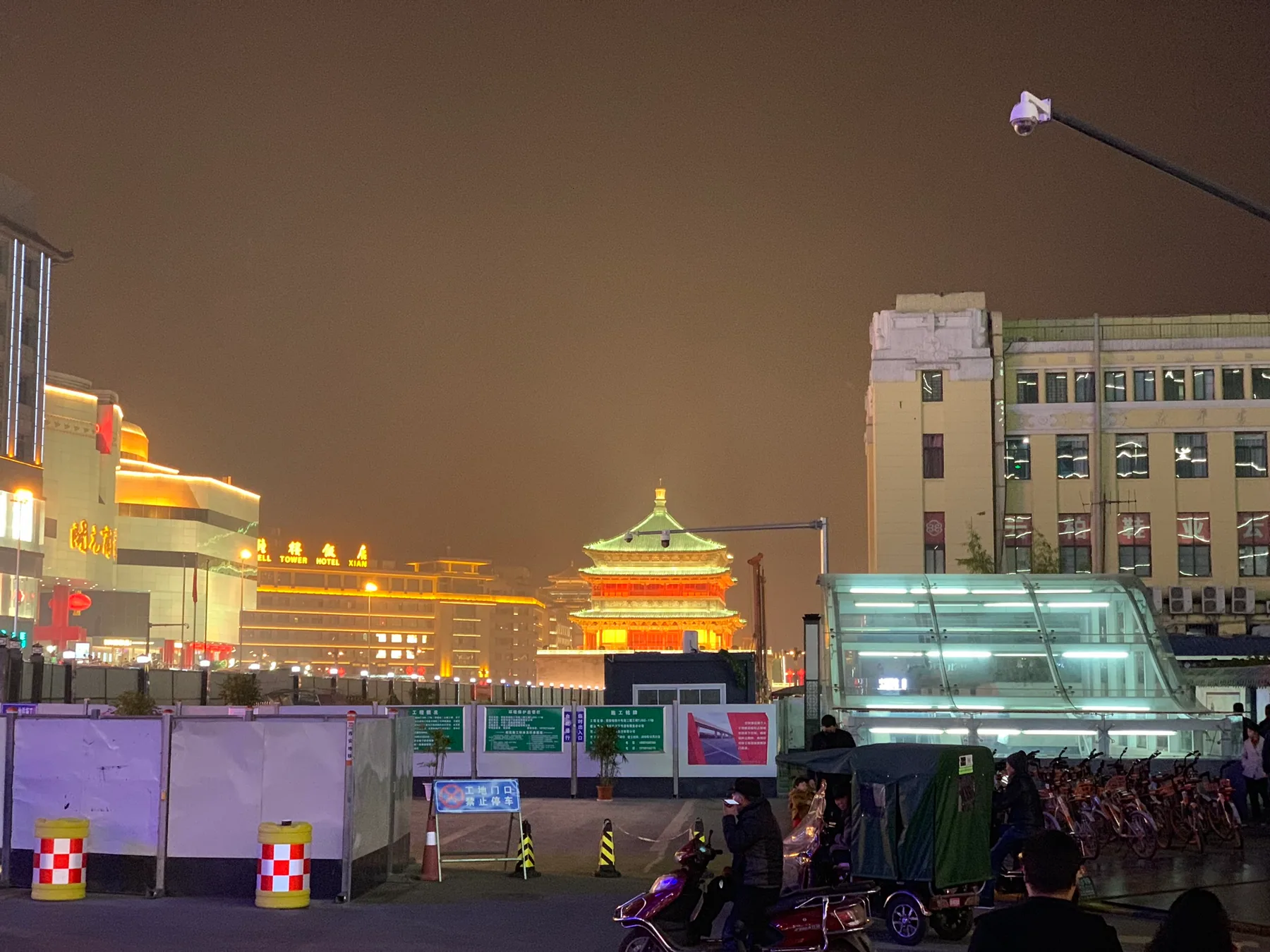 Xi’an city lights and traditional rooflines near the Bell Tower area at night.