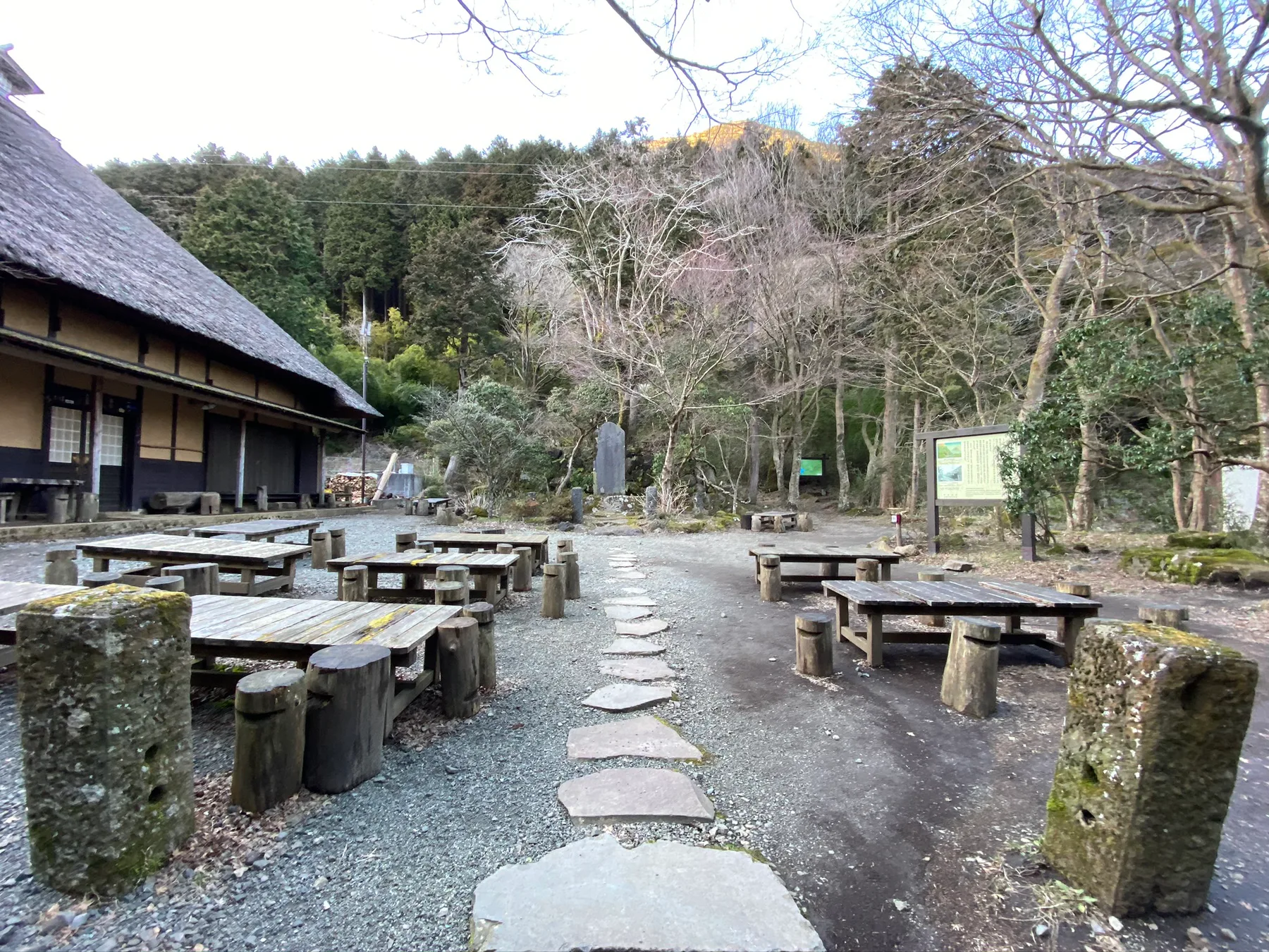 An empty tea house stop in Hakone surrounded by trees.