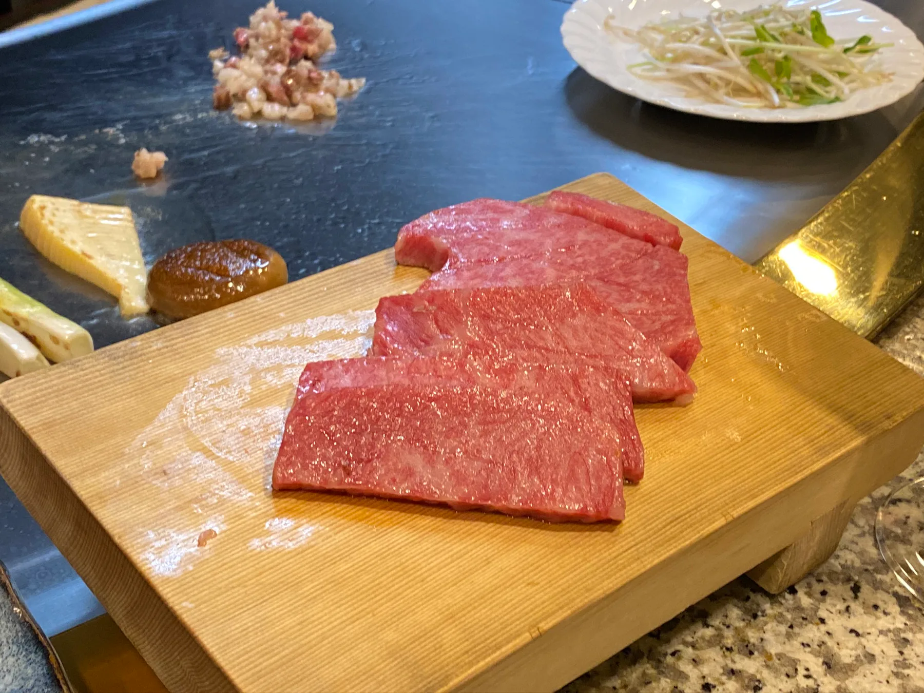 Kobe beef at the table with a beer nearby.