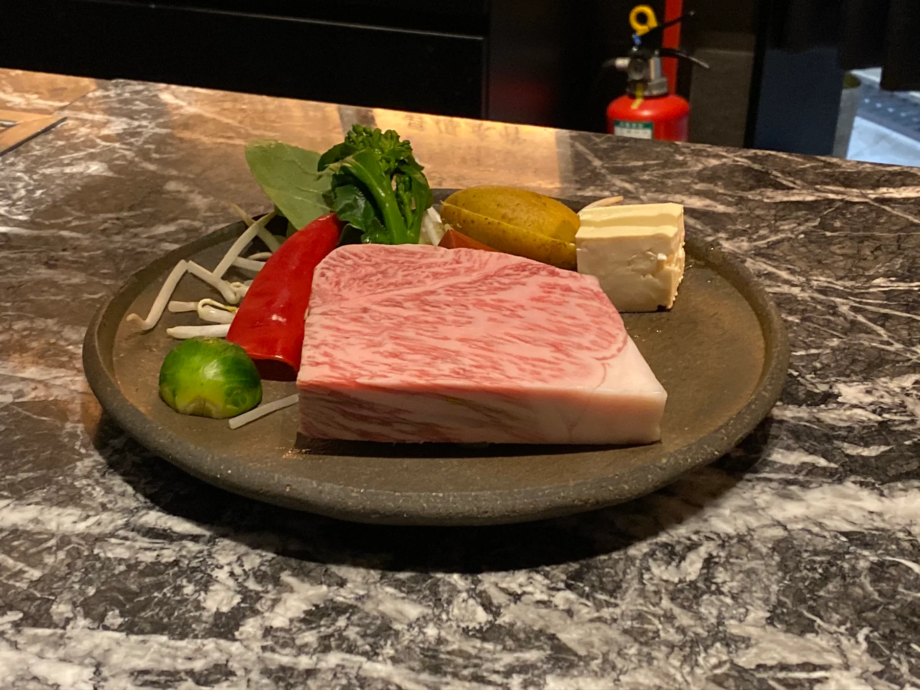 A Kobe beef course presented with vegetables.