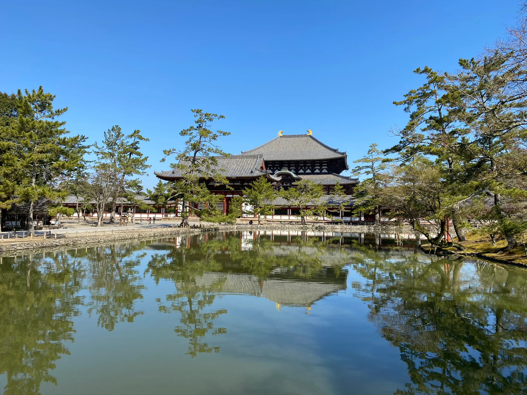 A temple reflected in water at Nara Park.