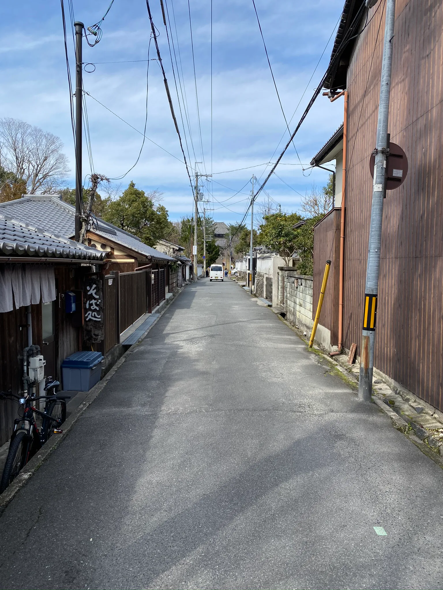 A quiet street lined with wooden buildings in Nara.