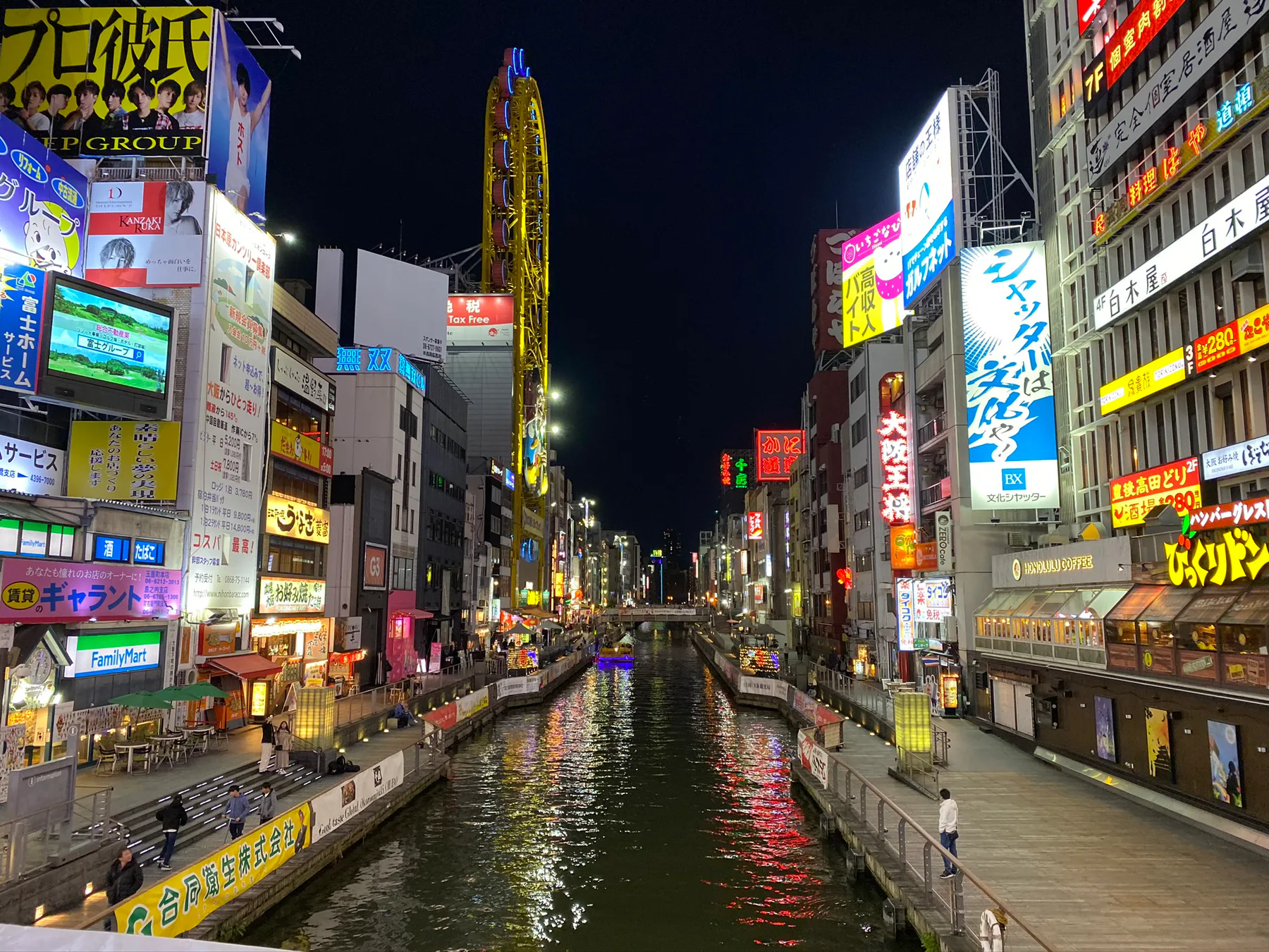 Dōtonbori lights reflected in the canal at night in Osaka.
