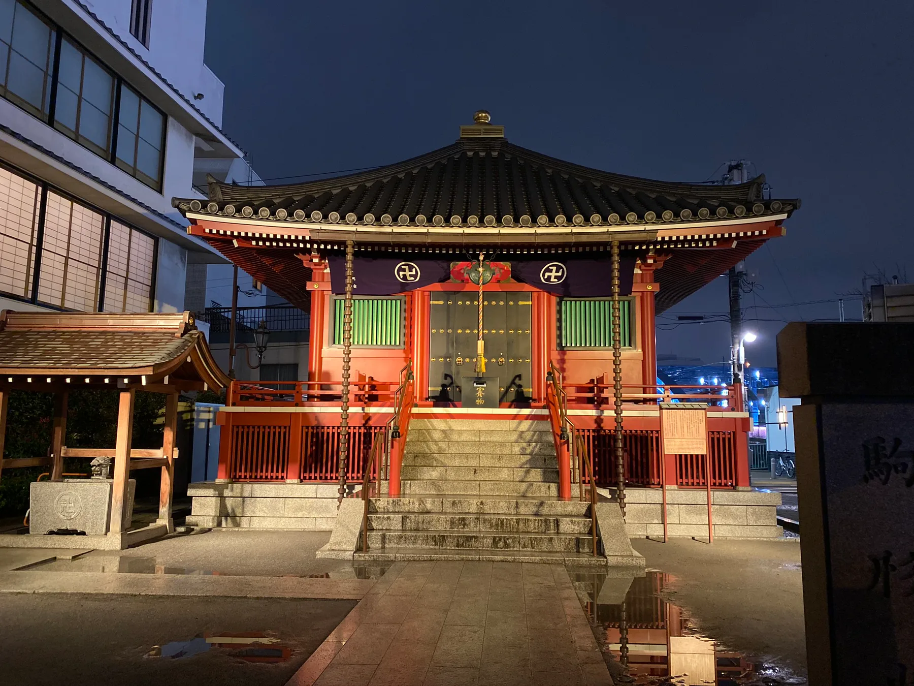 A lit temple building in Tokyo after dark.