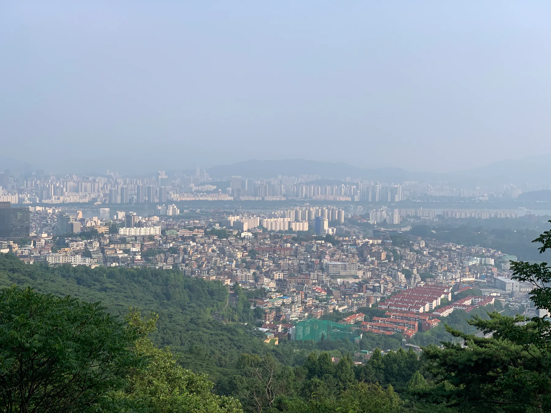 A hazy view over Seoul from above.