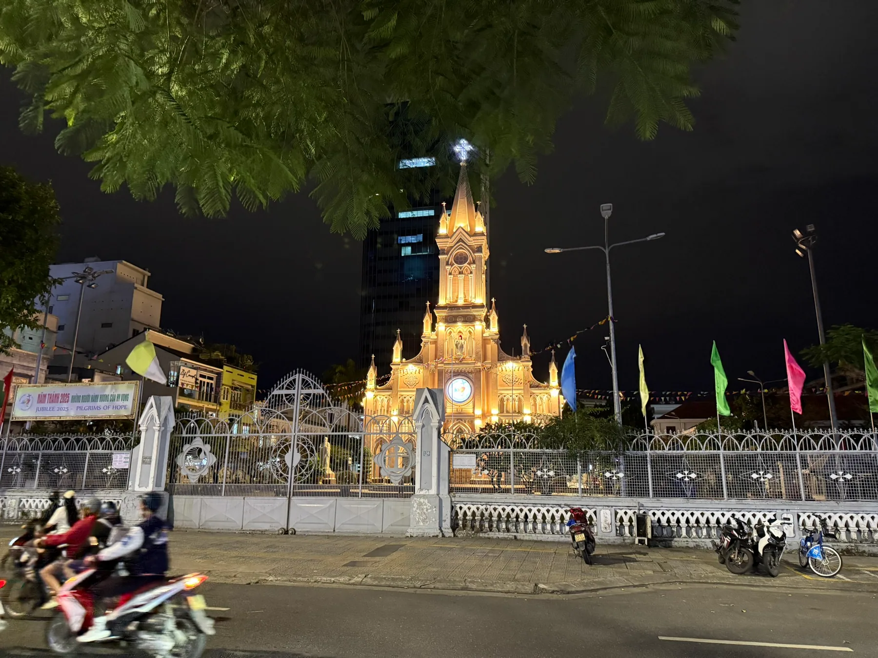 A lit church and street scene in Da Nang after dark.